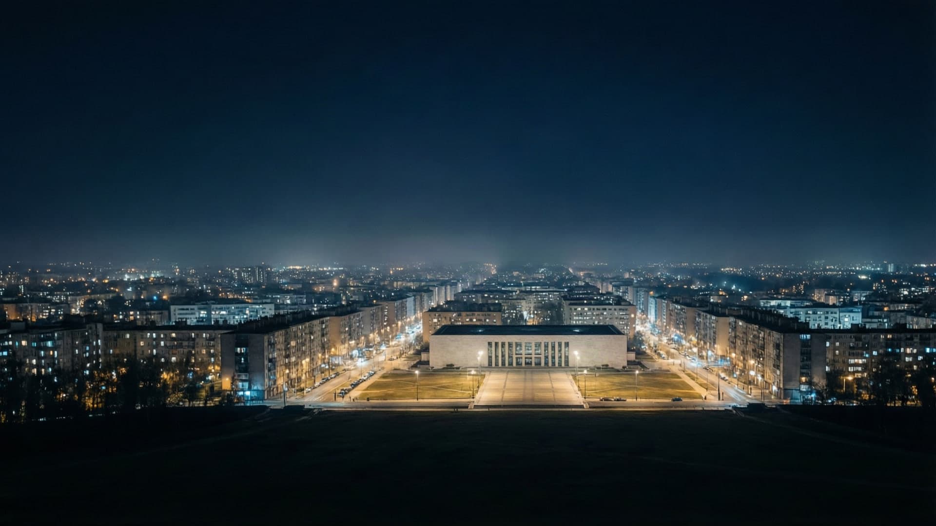 A wide night view of a capital city skyline with lit government buildings